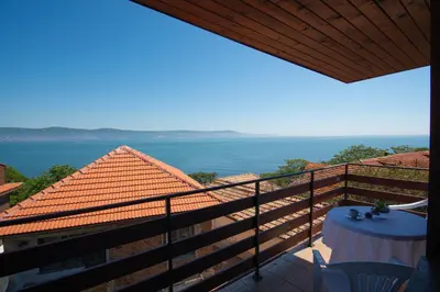 a balcony with a table and a view of the water at Royal Blue Apartments with Sea View in Old Nessebar in Nesebar