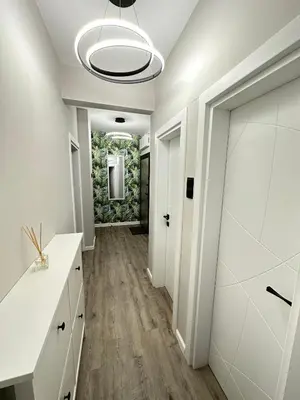 a hallway with white walls and a ceiling at Varna Cathedral Boutique Apartment in Varna City