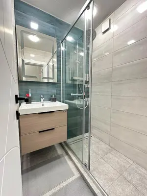 a bathroom with a sink and a glass shower at Varna Cathedral Boutique Apartment in Varna City