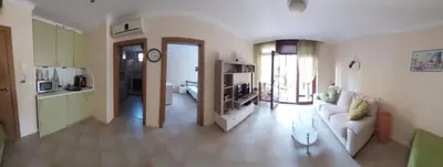 a living room with a couch and a kitchen at Санта Марина-Сладка къща in Sozopol