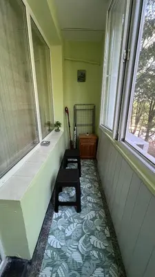 an empty room with a bench and a window at Сладкият кът на Радост in Burgas City