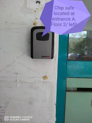 a cell phone hanging on a wall next to a door at Сладкият кът на Радост in Burgas City
