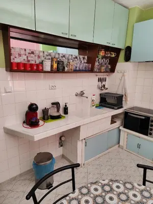 a small kitchen with a counter and a counter top at Сладкият кът на Радост in Burgas City