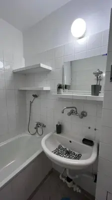 a bathroom with a sink and a bath tub at Сладкият кът на Радост in Burgas City