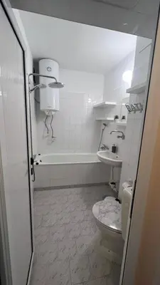 a bathroom with a toilet and a bath tub at Сладкият кът на Радост in Burgas City