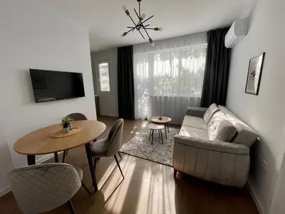 a living room with a couch and a table at Vanquish Central Apartment in Varna City