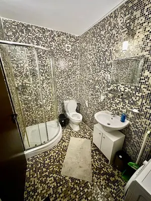 a bathroom with a shower and a toilet and a sink at Coastal Vibes Studio Burgas by Flat Mаnаger in Burgas City