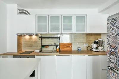 a kitchen with white cabinets and a counter top at Central flat Wi-Fi & streaming in Varna City
