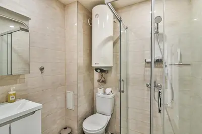 a bathroom with a shower and a toilet and a sink at Central flat Wi-Fi & streaming in Varna City