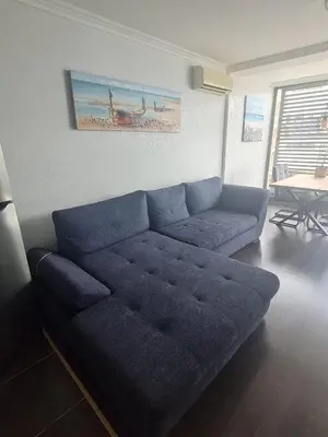 a blue couch in a living room with a table at Dolce Vita 2, Appartement in Sveti Vlas