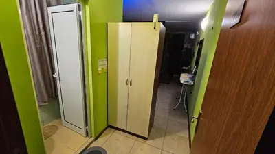 a bathroom with a door in a room with green walls at Studio 39 in Sunny Beach