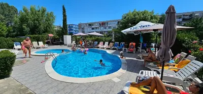 a group of people swimming in a swimming pool at Studio 39 in Sunny Beach
