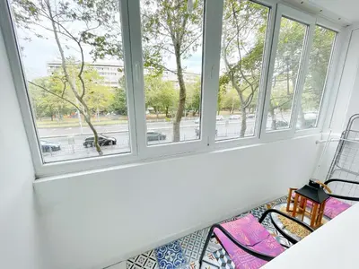 a room with three windows with pink chairs at Holiday Home in Burgas City