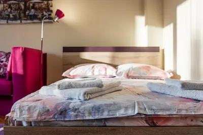 a bedroom with a bed with towels on it at Primorski 2bdrm Central Apartment in Varna City