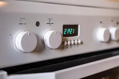 a close up of a stove with a clock on it at Primorski 2bdrm Central Apartment in Varna City