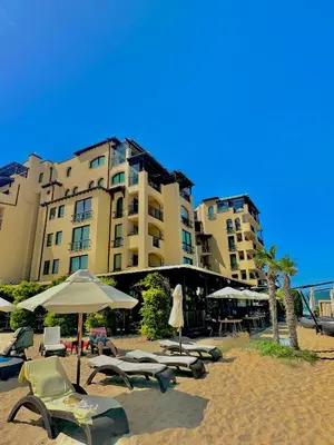 a group of chairs and umbrellas on a beach at Oazis VIP Club in Sunny Beach