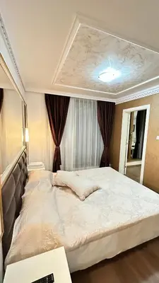 a bedroom with a large white bed in front of a window at Penthouse Happy Moments 3 in Sunny Beach