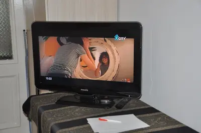 a television sitting on top of a table at Arlequin Apartment in Varna City