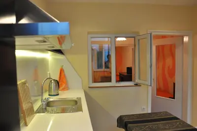 a small kitchen with a sink and a window at Arlequin Apartment in Varna City