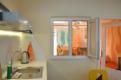 a kitchen with a sink and a window at Arlequin Apartment in Varna City