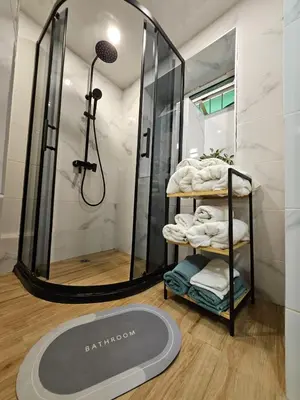 a bathroom with a shower and a rack with towels at ToP center of Varna in Varna City