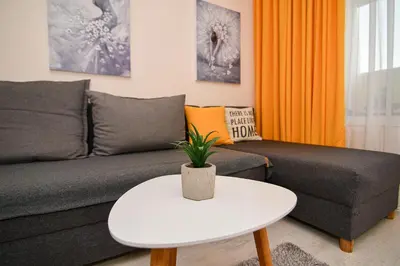a living room with a couch and a table at Central Paradise - free parking in Varna City