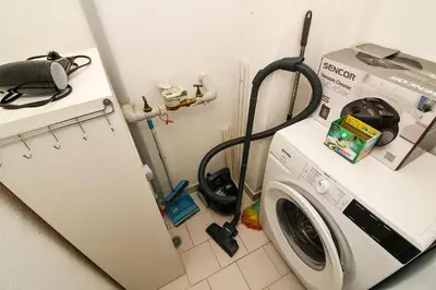 a washing machine in a kitchen next to a refrigerator at Central Paradise - free parking in Varna City