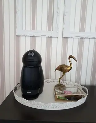 a bird statue sitting on a table with a toaster at Central Apartment 5min to beach in Varna City