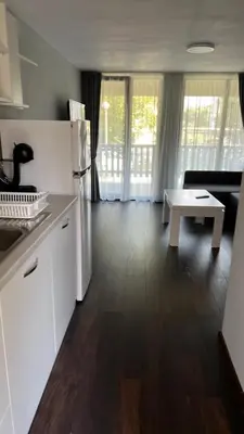 a kitchen with a white refrigerator and a table at Holiday Village Lozenets in Lozenets