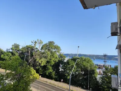 a view of a road with trees and a river at OPAL Beachfront Apartment in Varna City