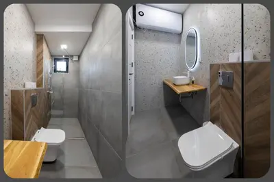 a bathroom with a toilet and a sink and a mirror at OPAL Beachfront Apartment in Varna City
