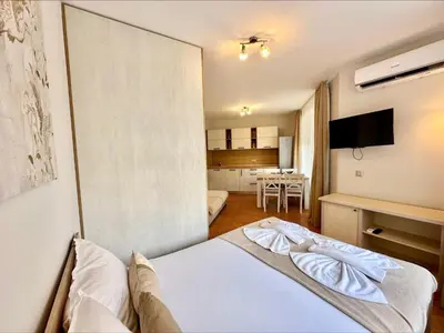 a hotel room with a bed and a kitchen at Panorama Dreams - Menada Apartments in Sveti Vlas