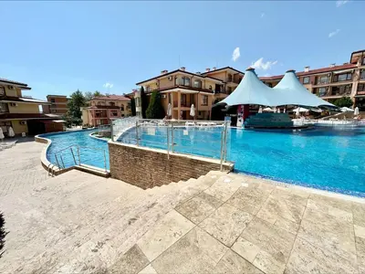 a large swimming pool with blue water in a building at Panorama Dreams - Menada Apartments in Sveti Vlas