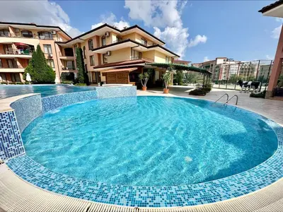 a large blue swimming pool in front of a building at Panorama Dreams - Menada Apartments in Sveti Vlas