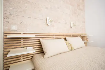 a small bedroom with a bed and a desk at Demokratsia bl 117 in Burgas City