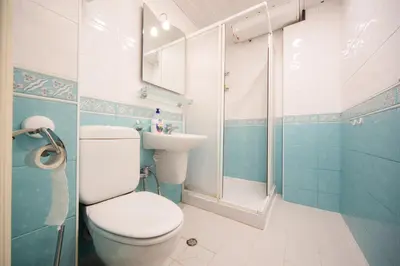 a bathroom with a toilet and a sink at Demokratsia bl 117 in Burgas City