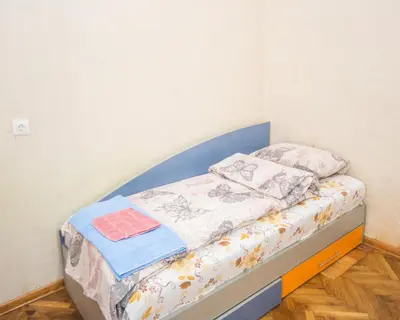 a small bed in a corner of a room at The Square - Old Flat with 2 bedrooms, 1st fl in Burgas City