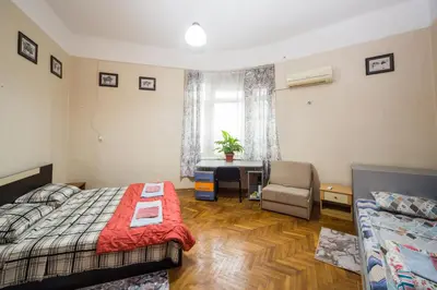 a bedroom with a bed and a desk and a window at The Square - Old Flat with 2 bedrooms, 1st fl in Burgas City