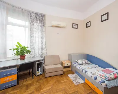 a bedroom with a bed and a desk and a chair at The Square - Old Flat with 2 bedrooms, 1st fl in Burgas City