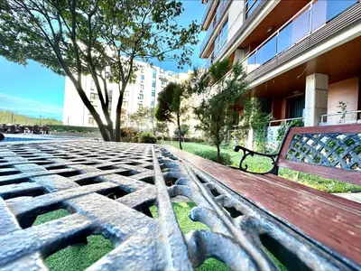 a wooden bench sitting next to a building at Pomorie Bay - Menada Apatments in Pomorie