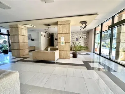 a lobby with a couch and some windows at Pomorie Bay - Menada Apatments in Pomorie