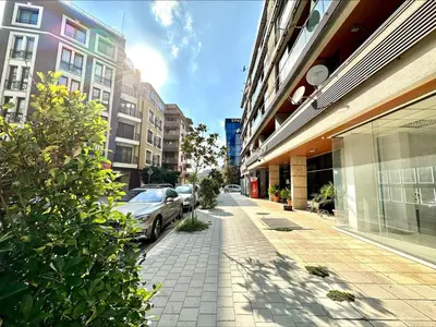 a city street with cars parked on the sidewalk at Pomorie Bay - Menada Apatments in Pomorie