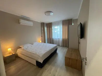 a bedroom with a bed and a television in it at City Center Apartment 2 in Varna City