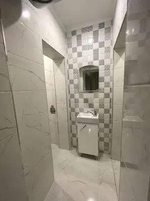 a bathroom with a toilet and a sink and a mirror at City Center Apartment 1 in Varna City