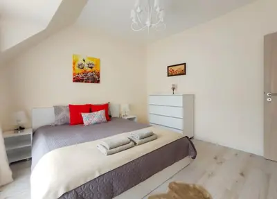 a bedroom with a large bed with red pillows at Beachfront Panoramic Flat @ South Bay residence in Varna City