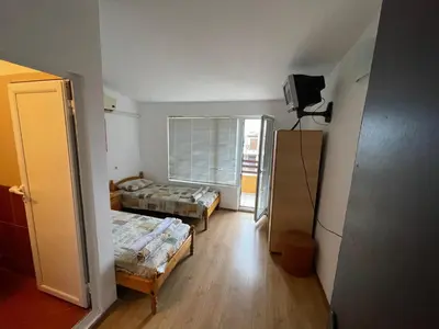 a small room with two beds and a window at Orange House in Sozopol