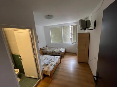 a room with a room with two beds and a window at Orange House in Sozopol