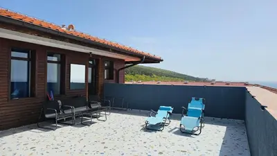 a group of chairs sitting on a patio at Квартира с потрясающим видом in Sveti Vlas