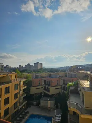 a view of a city with buildings and a pool at Таунхаус с шикарной террасой in Sveti Vlas