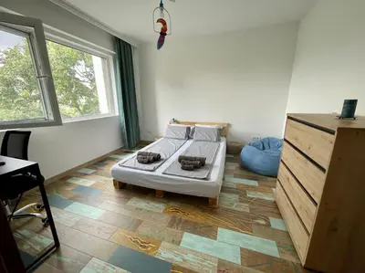 a bedroom with a bed in the corner of a room at Sunny Seaside Retreat in Burgas in Burgas City